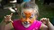 © Fotoforce - The face of a girl painted with colorful paints. Painting children's faces during a family picnic.