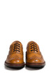 Closeup of Pair of Tanned Brogue Derby Shoes of Calf Leather with Rubber Sole Over Pure White Background.