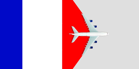 Flag of France and the plane. The concept of travel. Toy airplane on the flag of France.