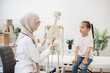 © sofiko14 - GP consulting tween kid about human body by anatomical model