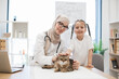© sofiko14 - Woman in hijab and child posing near furry pet on vet visit