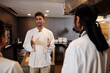 © DragonImages - Indian restaurant chef talking to his team to cheer them up before long shift