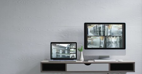 Poster - Wall mounted computer monitor and laptop on desk with security camera views on screens, slow motion