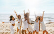 © Prostock-studio - Bachelorette party celebration. Group of women dancing on the beach, having fun and enjoying hen party on ocean shore