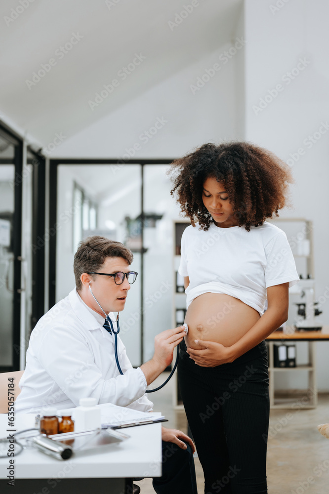 Pregnant african woman has appointment with doctor at clinic. Male ...