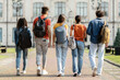 © Prostock-studio - Group of five students with backpacks walking at university campus together
