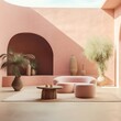 This minimalist pink patio design is the perfect blend of cozy outdoor living, featuring a round table, comfortable couch, vibrant flowerpots, lush houseplants, and a wall of hacienda style buildings