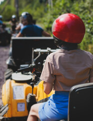 Wall Mural - Group of riders riding ATV vehicle crossing forest rural road, process of driving rental vehicle, all terrain quad bike vehicle, during off-road tour adventure competition in a summer sunny day