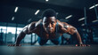 © Prasanth - a black afro-american athlete with healthy muscular body doing pushups in a gym while sweating and improving his physical body form.