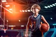 Beautiful Basketball teen male player holding a basket ball posing in basket sports hall.