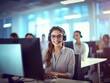Portrait of friendly female customer support representative in headset with microphone talking with client in customer support service office.
