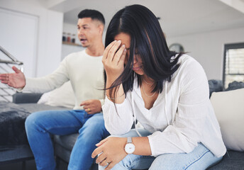 Wall Mural - Frustrated couple, headache and fight in divorce, conflict or disagreement on living room sofa at home. Unhappy man and woman in breakup, cheating affair or dispute from toxic relationship in house