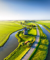 Wall Mural - a drone view of windmills in holland. windmills on the banks of canals. agricultural fields and past