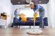 © Rakchanok - Asian cleaning services housekeeper women swipe floor and remove dust from sofa in living room, group of housemaid workers female wearing gloves working, small business cleaning services concept
