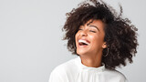 Beautiful african american girl with an afro hairstyle smiling. Smiling beautiful afro girl. Curly black hair. Emotion concept.
