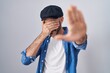 © Krakenimages.com - Hispanic man with beard standing over isolated background covering eyes with hands and doing stop gesture with sad and fear expression. embarrassed and negative concept.