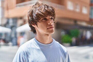 Sticker - Young blond man looking to the side with serious expression at street