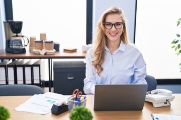 Wall Mural - Young blonde woman business worker using laptop working at office