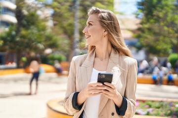 Poster - Young blonde woman smiling confident using smartphone at park