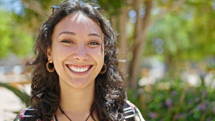 Wall Mural - Young beautiful hispanic woman smiling confident standing at park