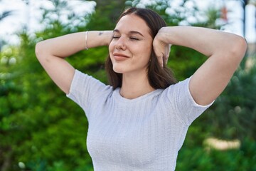 Sticker - Young woman smiling confident with hands on ears at park