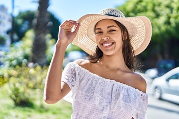 Sticker - Young african american woman tourist smiling confident wearing summer hat at park