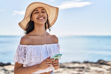 Sticker - Young african american woman tourist smiling confident using smartphone at seaside