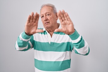 Sticker - Senior man with grey hair standing over white background doing frame using hands palms and fingers, camera perspective