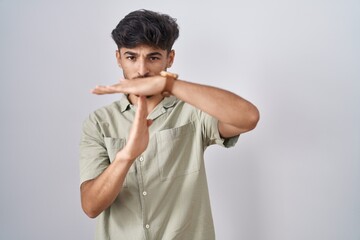 Wall Mural - Arab man with beard standing over white background doing time out gesture with hands, frustrated and serious face