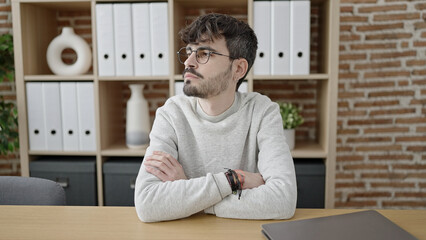 Wall Mural - Young hispanic man business worker smiling confident standing at office