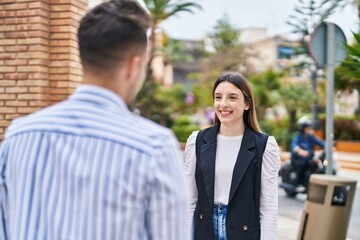 Wall Mural - Man and woman couple smiling confident standing together at street