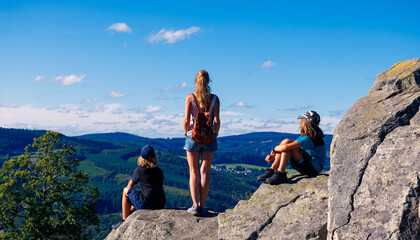 Wall Mural - woman and children on mountain peak looking at panoramic view- Family hiking, tourism,adventure concept