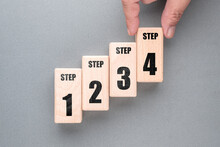 Hand Arrange The Wood Blocks As Staircase To Show The Step Method From One To Four