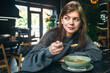 © puhimec - Attractive woman is eating vegetable soup in a cafe.