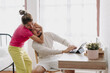 © Sevendeman - Asian wife pulling husband out of the desk to stop working. Funny couple fight.
