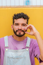 Young Bearded Man Looking At Camera Against Yellow Background