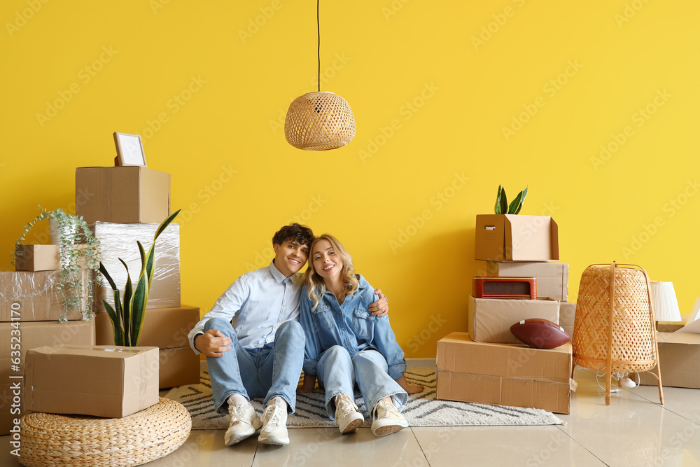 Happy young couple hugging in room on moving day