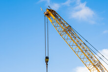 A Yellow Crane At A Construction Site During A Sunny Day