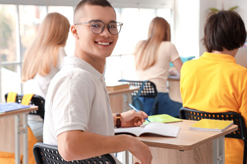 Canvas Print - Male student having lesson in classroom