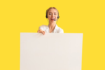 Wall Mural - Female technical support agent with blank poster on yellow background