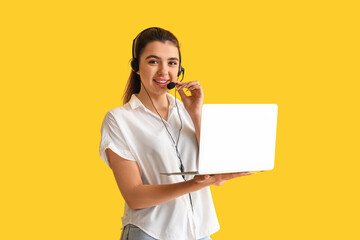 Wall Mural - Female technical support agent with laptop on yellow background