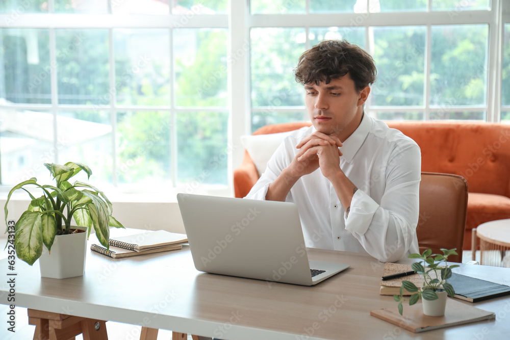 Young man having job interview online  at home