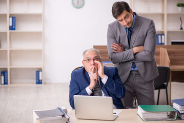 Wall Mural - Two male colleagues working in the office