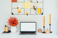 Home Office Desk With Open Laptop Mockup, Grid Mood Board With Fall Colors Palette And Seasonal Decor Like Candles, Flowers, Pumpkins. Autumn Inspiration And Cozy Mood. Hygge Home Fall Decor.
