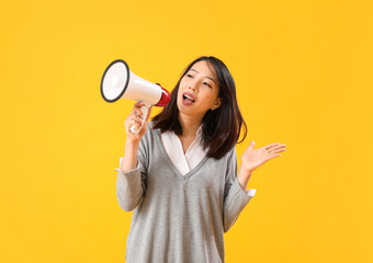 Sticker - Beautiful Asian woman shouting into megaphone on yellow background. Dialogue concept