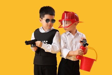 Poster - Cute little policeman and firefighter on yellow background