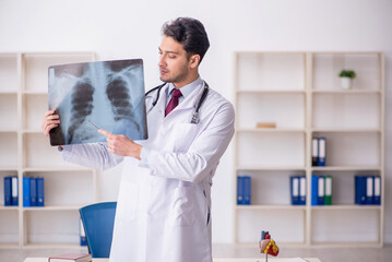 Wall Mural - Young male doctor radiologist working in the clinic