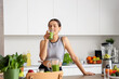 © Pixel-Shot - Sporty young woman drinking healthy smoothie in kitchen