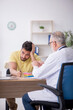 © Elnur - Young male patient visiting old male doctor