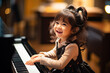 a young girl is playing the piano and laughing, in the style of youthful energy